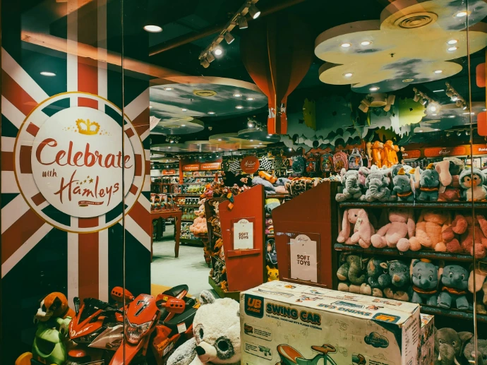 A toy store, hamleys, with many shelves of toys.